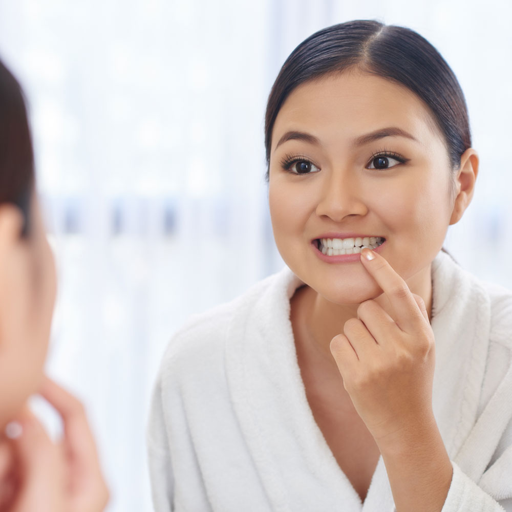 dental patient looking in the mirror Chicago IL